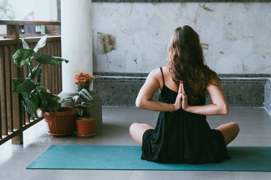 woman practicing yoga pose behind her back