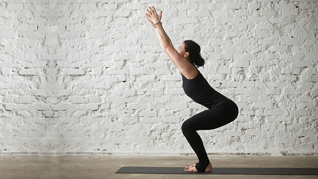 woman-in -black-leggings-practicing-yoga-chair-pose