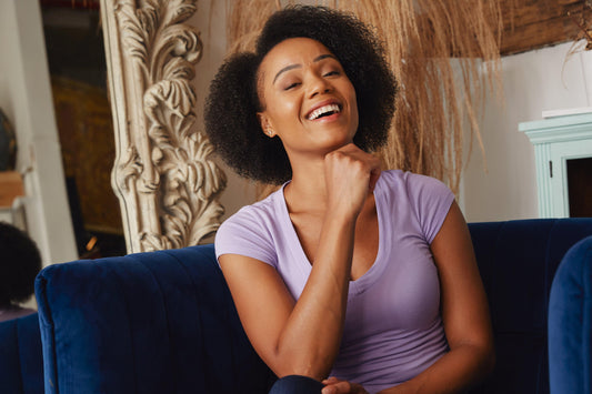 female-model-smiles-in-blue-chair