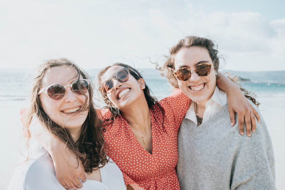 three-woman-in-sunglasses-smile-wide-for-the-camera