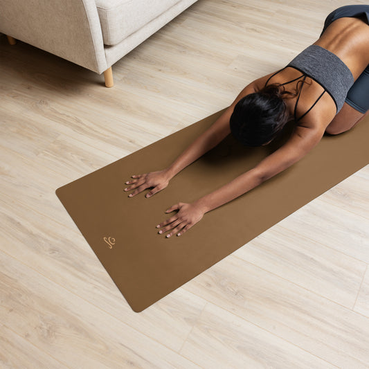 woman-doing-yoga-pose-on-dark-brown-yoga-mat