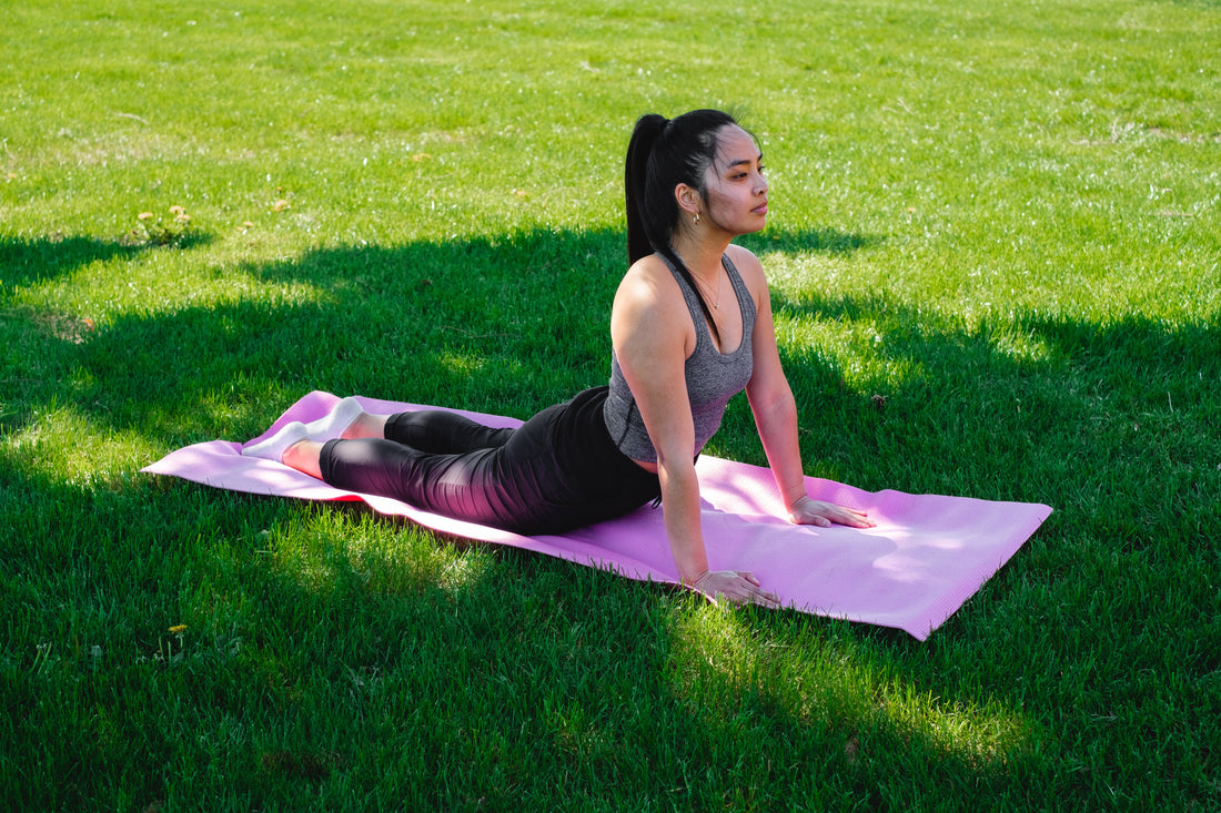 woman-practices-yoga-in-green-grass