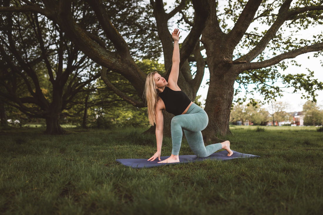 woman-practices-yoga-under-a-large-tree