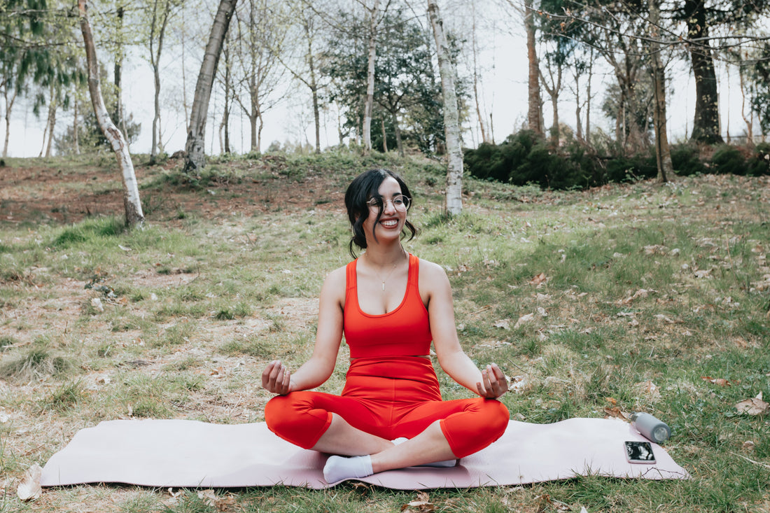 woman-smiles-while-sitting-in-a-yoga-pose