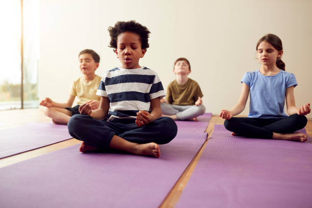 oga for kids - Group of children of different ages doing yoga poses
