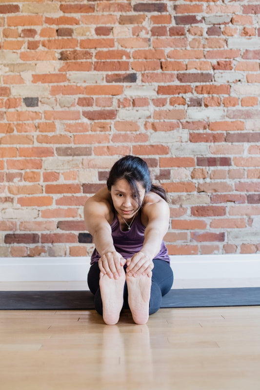 young-woman-touching-toes-in-yoga